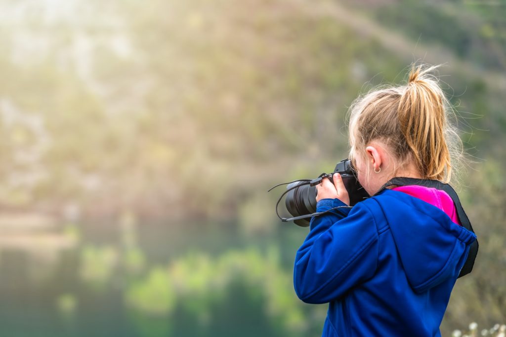 Little girl photographing nature