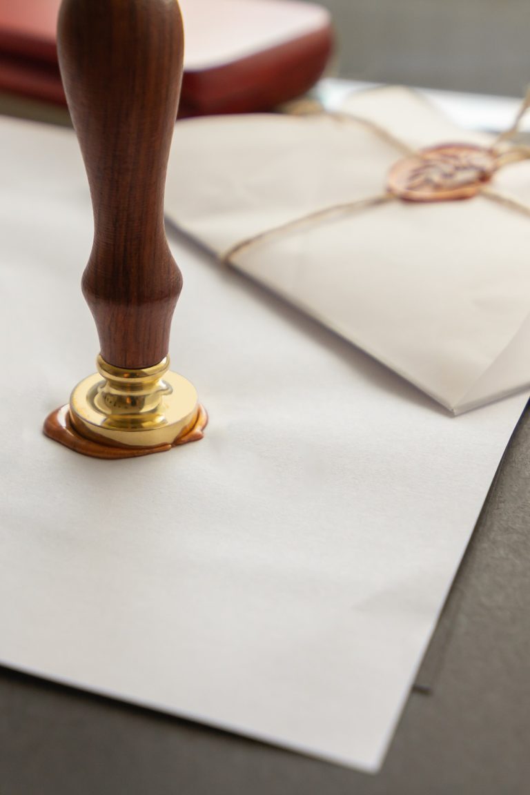 Notary public wax stamper. White envelope with brown wax seal, golden stamp. Responsive design